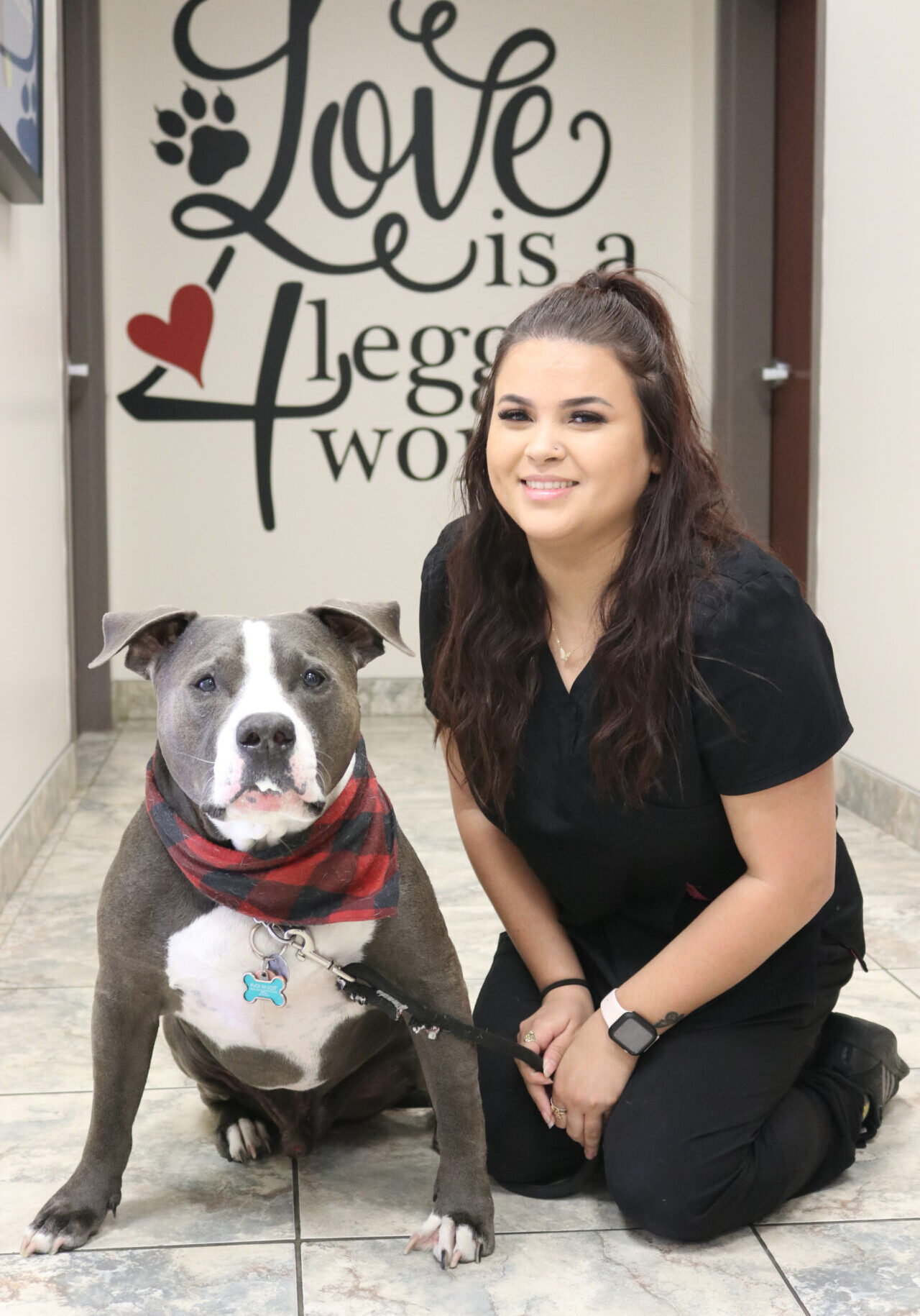 A woman and her dog pose for the camera.