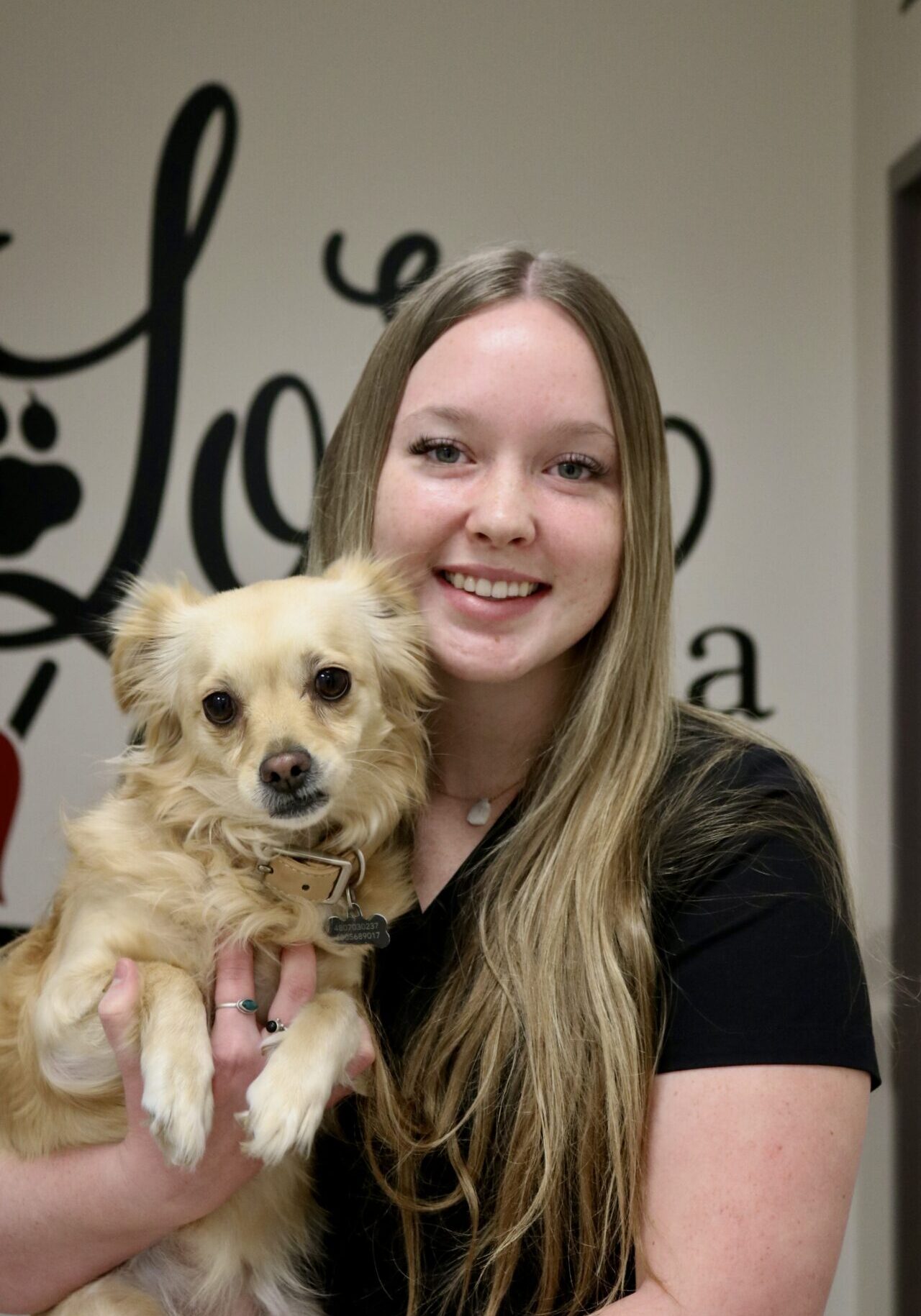 A woman holding a dog in her arms.