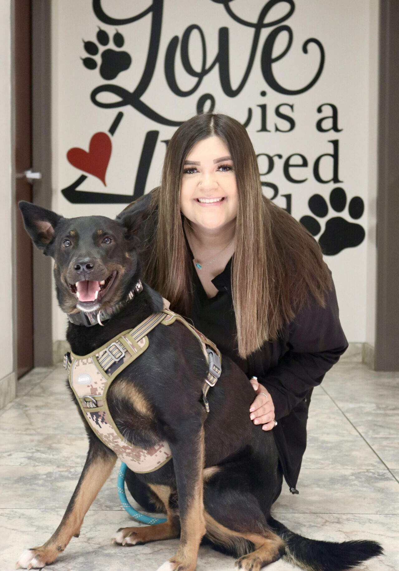 A woman and her dog pose for the camera.